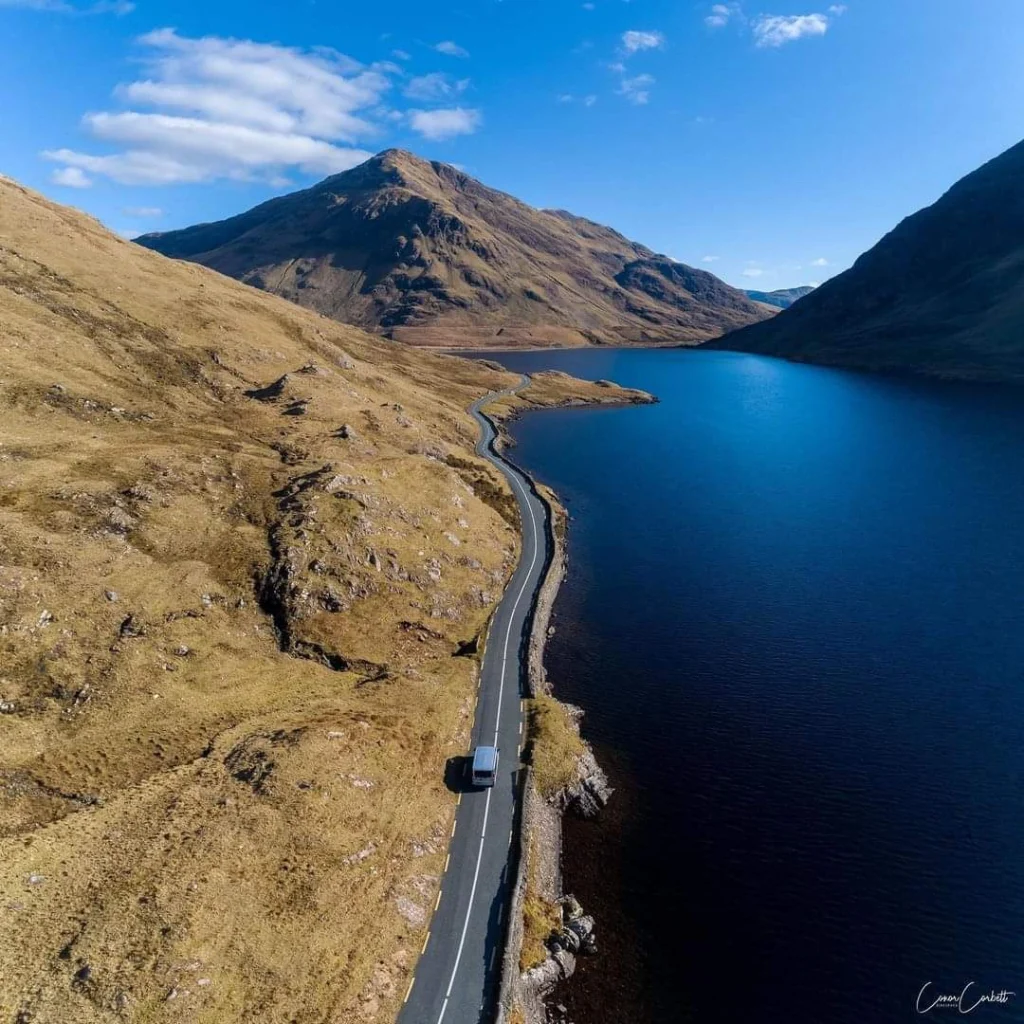 Irish Culture Tours - car driving on road by lake and mountains