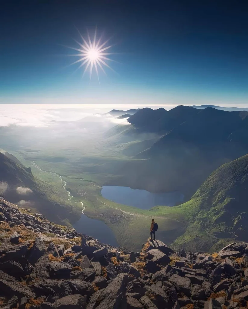 Man overlooking scenic mountains - Seven Wonders of Ireland